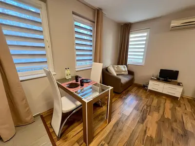 a living room with a glass table and a couch at Cozy One-Bedroom Apartment near Burgas Sea Garden in Burgas City