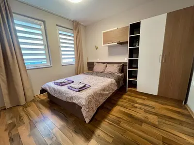 a bedroom with a bed and a book shelf at Cozy One-Bedroom Apartment near Burgas Sea Garden in Burgas City