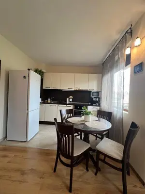 a kitchen with a table and chairs and a refrigerator at Apartment Chocolate Ravda in Ravda