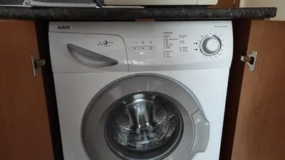 a washer and dryer with a counter above it at Double Cherry Apartment in Sunny Beach