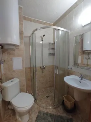 a bathroom with a shower and a toilet and a sink at Double Cherry Apartment in Sunny Beach