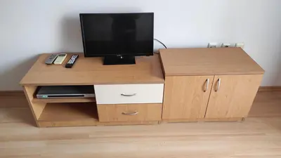 a wooden entertainment center with a television on top at Double Cherry Apartment in Sunny Beach