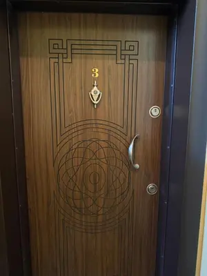 a wooden door with a symbol on it at Apartment Maria in Burgas City
