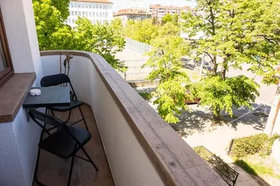 a balcony with two chairs and a table on it at Apartment Maria in Burgas City