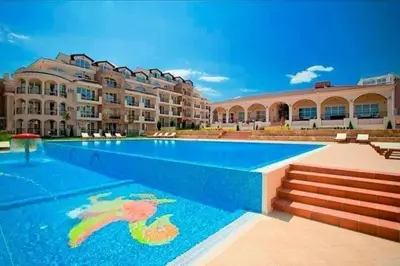 a swimming pool in front of a building at Студио Черноморски залив Атия Резорт in Chernomorets