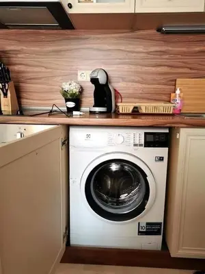 a kitchen with a washing machine on a counter at Студио Черноморски залив Атия Резорт in Chernomorets