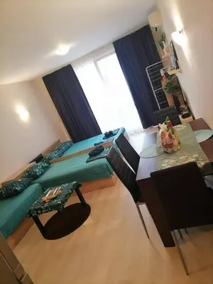 a bedroom with a bed and a desk and a table at Студио Черноморски залив Атия Резорт in Chernomorets