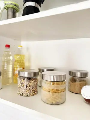 a shelf with four glass jars filled with food at Urban Oasis in Varna City