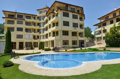 a large apartment building with a swimming pool in front of it at Splendid sunny seasons in Byala