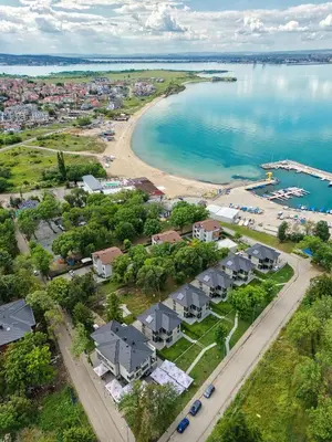 an aerial view of a beach with houses and the water at Marina Bay Apartments Kraymorie in Burgas City