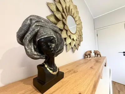 a bust of a woman with a hat on a table at Sea Garden luxury appartments in Varna City