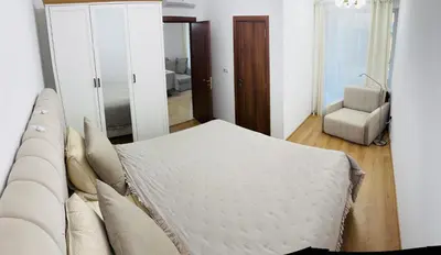 a bedroom with a bed and a couch at Grand Villa Perle in Sveti Vlas