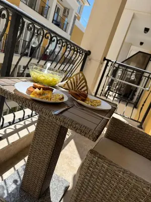 a table with two plates of food on a balcony at Grand Villa Perle in Sveti Vlas