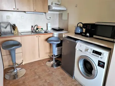 a kitchen with a sink and a washing machine at Апартамент Цар Самуил in Burgas City