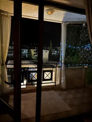 a window with a view of a city at night at Apartment in complex Sirena! in Sveti Vlas