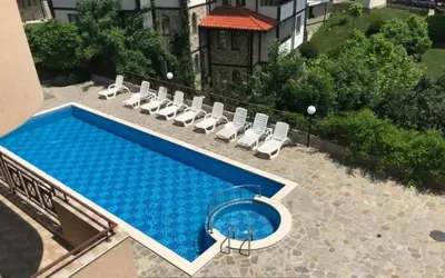 a swimming pool with lounge chairs and a swimming poolvisor at Apartment in complex Sirena! in Sveti Vlas