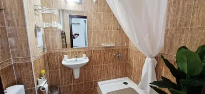 a bathroom with a sink and a toilet and a mirror at Apartment in complex Sirena! in Sveti Vlas