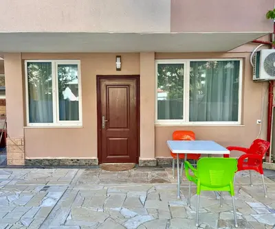 a table and chairs in front of a house at Студио Боряна in Pomorie