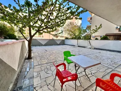 a table and four chairs on a stone patio at Студио Боряна in Pomorie
