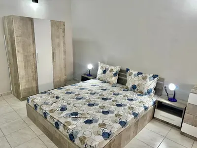 a bedroom with a large bed in a room at Студио Боряна in Pomorie