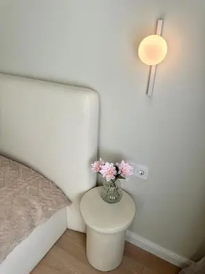 a vase with flowers on a table in a bedroom at Heart of Varna, Close to the Sea in Varna City