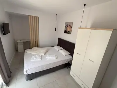 a small bedroom with a bed and a cabinet at Hotel 415 in Sunny Beach