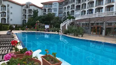 a large blue swimming pool in front of a building at Studio Blue Triumph in Sveti Vlas