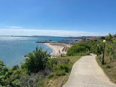 a path next to a beach next to the water at Studio Blue Triumph in Sveti Vlas