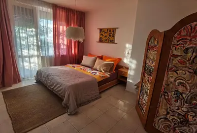 a bedroom with a bed and a large window at Вила Алба in Lozenets