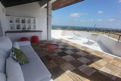 a living room with a couch and a table at Вила Алба in Lozenets