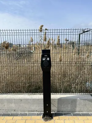 a parking meter in front of a fence at Lago Mare Apartment in Pomorie