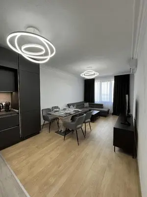 a large living room with a table and chairs at Lago Mare Apartment in Pomorie
