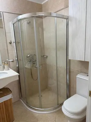 a shower stall in a bathroom with a toilet at Flores Garden Pool & Sea View Studio in Chernomorets