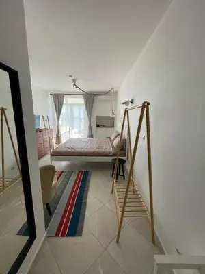 a room with a bed and a ladder in it at Flores Garden Pool & Sea View Studio in Chernomorets