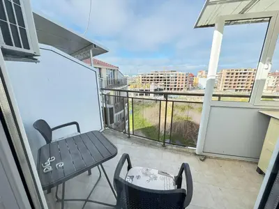 a balcony with a table and chairs on a balcony at Pomorian Pearl in Pomorie