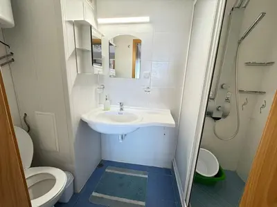 a small bathroom with a sink and a toilet at Pomorian Pearl in Pomorie