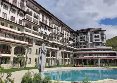 a hotel with a swimming pool in front of a building at 3 комнатные новые апартаменты у моря in Sveti Vlas