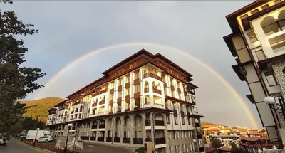 a rainbow in the sky above a building at 3 комнатные новые апартаменты у моря in Sveti Vlas