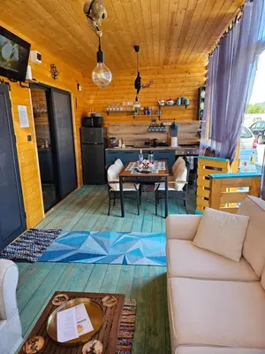 a living room with a couch and a table at Бунгало HAKUNA MATATA, Къмпинг Созопол Еко, плаж Градина in Sozopol