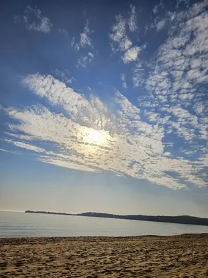 a beach with a cloudy sky and the ocean at Бунгало HAKUNA MATATA, Къмпинг Созопол Еко, плаж Градина in Sozopol