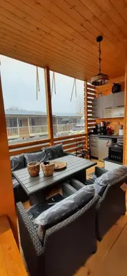 a living room with a table and a couch at Бунгало Шангри Ла-3, плаж Градина in Sozopol