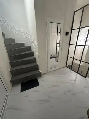 a staircase in a room with a door and aoyer with a stairvisor at Family in Varna City