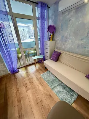 a living room with a couch and a window at Family in Varna City