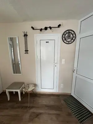 a room with a door and a clock on the wall at Family in Varna City