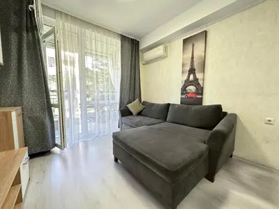 a living room with a couch and a large window at Apartment in Sveti Vlas in Sveti Vlas