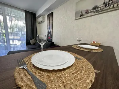 a table with a plate and a fork and knife at Apartment in Sveti Vlas in Sveti Vlas
