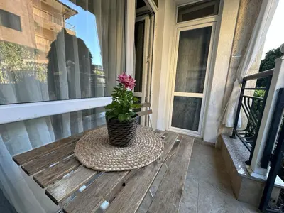a potted plant sitting on a table on a porch at Apartment in Sveti Vlas in Sveti Vlas