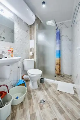 a bathroom with a shower and a toilet and a sink at АПАРТАМЕНТИ Радина in Pomorie
