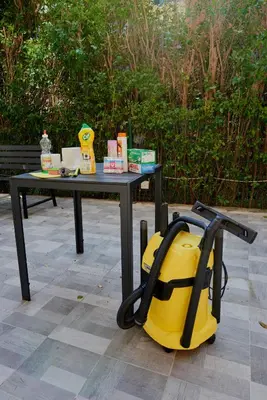 a table with a yellow bag sitting next to it at АПАРТАМЕНТИ Радина in Pomorie