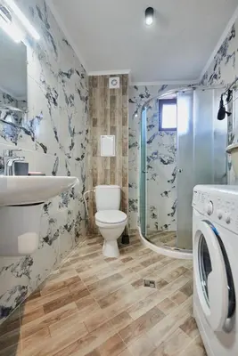 a bathroom with a toilet and a sink and a shower at АПАРТАМЕНТИ Радина in Pomorie